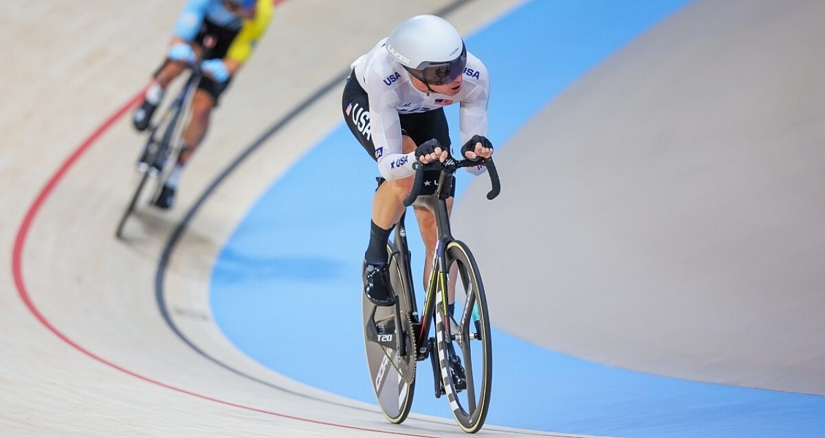 A man drive the sports cycle on racing track.
