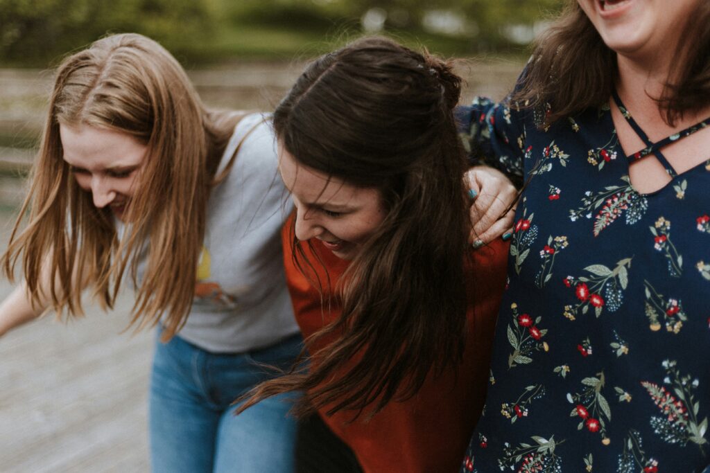 Beautiful girls are laughing while conversation.
