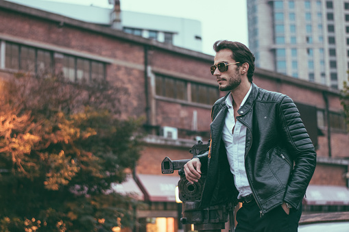 A boy wearing the black leather jacket.

